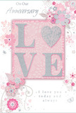 This anniversary card captures the feeling of enduring romance, much like the thoughtful bouquets exchanged between partners across Belmont each year. At its centre, the word LOVE is spelled out in raised glitter letters, giving a gentle, tactile sparkle that stands out against a background of soft pastel pink. The letter shapes are smooth and inviting, with the subtle shimmer reminiscent of early morning light on petals in a florist's display. Surrounding this focal word, an array of delicate blooms unfolds-stylised blossoms in blush, mauve, and ivory tones, their edges softened as though painted in watercolour. Fine curling lines suggest stems and vines, weaving gracefully between the flowers and lending a sense of movement, like a gentle breeze drifting through a spring garden. Tiny details-scattered petals, swirling flourishes, and faint butterfly motifs-introduce a hint of playfulness without overwhelming the calm, romantic mood. Hints of silver and grey add refinement, echoing the shimmer of gift wrap or ribbon prepared for an anniversary delivery nearby. The phrases On Our Anniversary and I love you today and always appear in elegant script, flowing across the design with the ease of handwritten vows. Overall, the card feels like a soft-spoken declaration, visually echoing the tenderness of a carefully chosen bouquet-quiet yet profoundly heartfelt, ideal for celebrating a shared journey in Belmont.